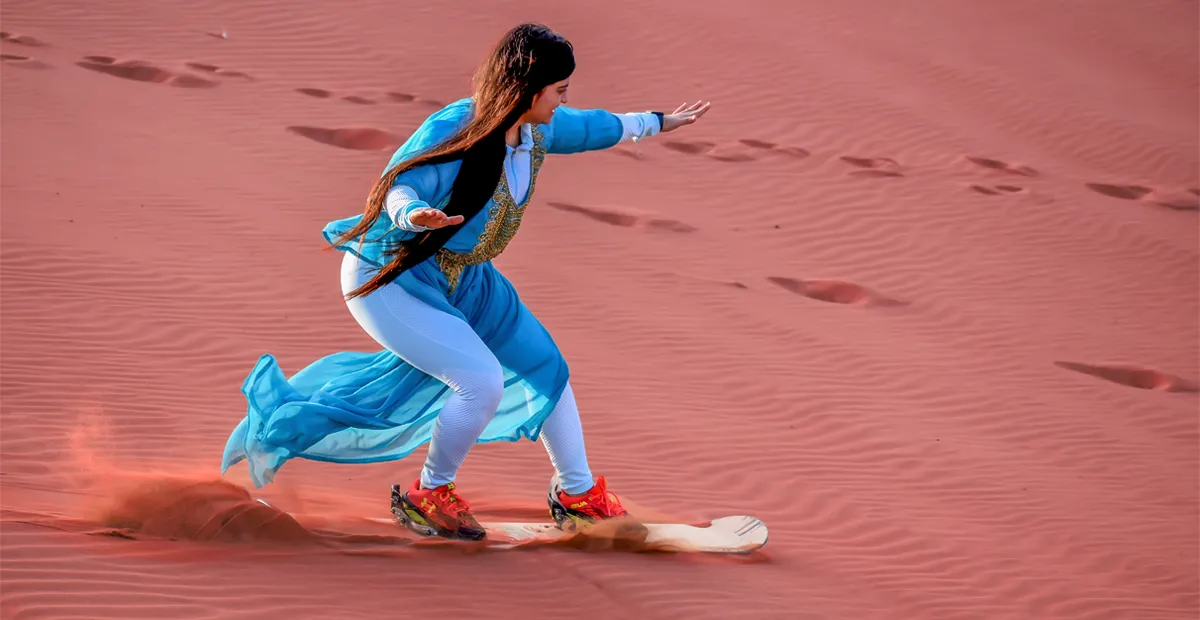Sandboarding during evening desert safari Dubai
